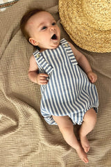 Extra light and breathable baby romper features blue and white stripes. Crafted from organic cotton, it has adjustable straps to ensure a longer fit.
