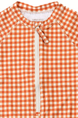 The long sleeve swimsuit for girls with rashguard and ruffle in Sienna Gingham by Grech and Co. Shop the best sustainable girl swimsuit online at MiliMilu.