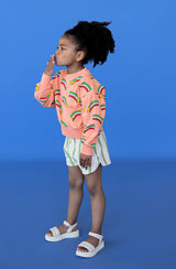Shop girls & tweens organic cotton sweaters with a modern twist - long puff sleeves in peach colour with stars. Sweater for spring and summer in bright colours.