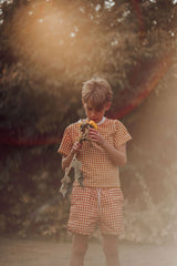  GRECH & CO boys swim trunks in Sienna Gingham are made with sustainable recycled material, providing UPF 50+ sun protection and ultra-comfortable online.