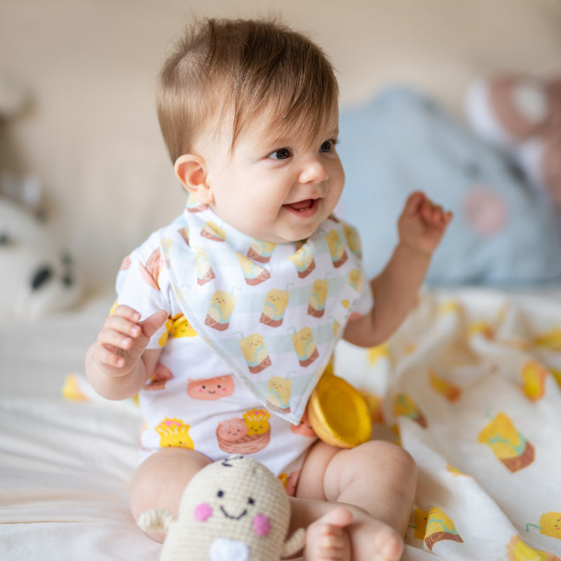 baby wearing the wee bean organic cotton bib set in vita lemon iced tea