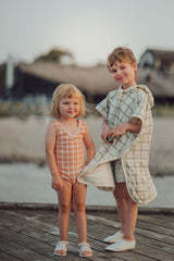 Grech & Co organic cotton towel poncho in fern green is the perfect blend of comfort. The retro-inspired hooded beach poncho for kids, shop kids beach clothing.