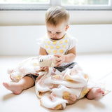 cute baby playing with the wee bean dim sum swaddle