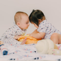 cute kids bumping heads wearing the wee bean's bunny candy onesies