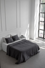 Bed With Charcoal Linen Bedding Set In A White Spacious Room